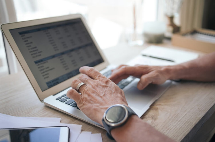 man working on online rent ledger